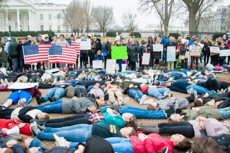 Students protest gun law by staging a lie-in outside the whitehouse. Source: Rena Schild/Shutterstock.