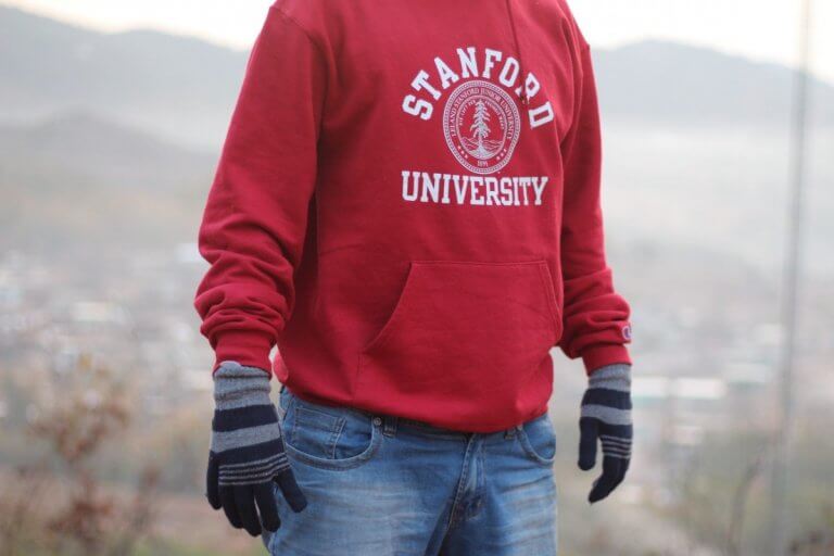 Do student travellers wear their university hoodies as a symbol of pride?