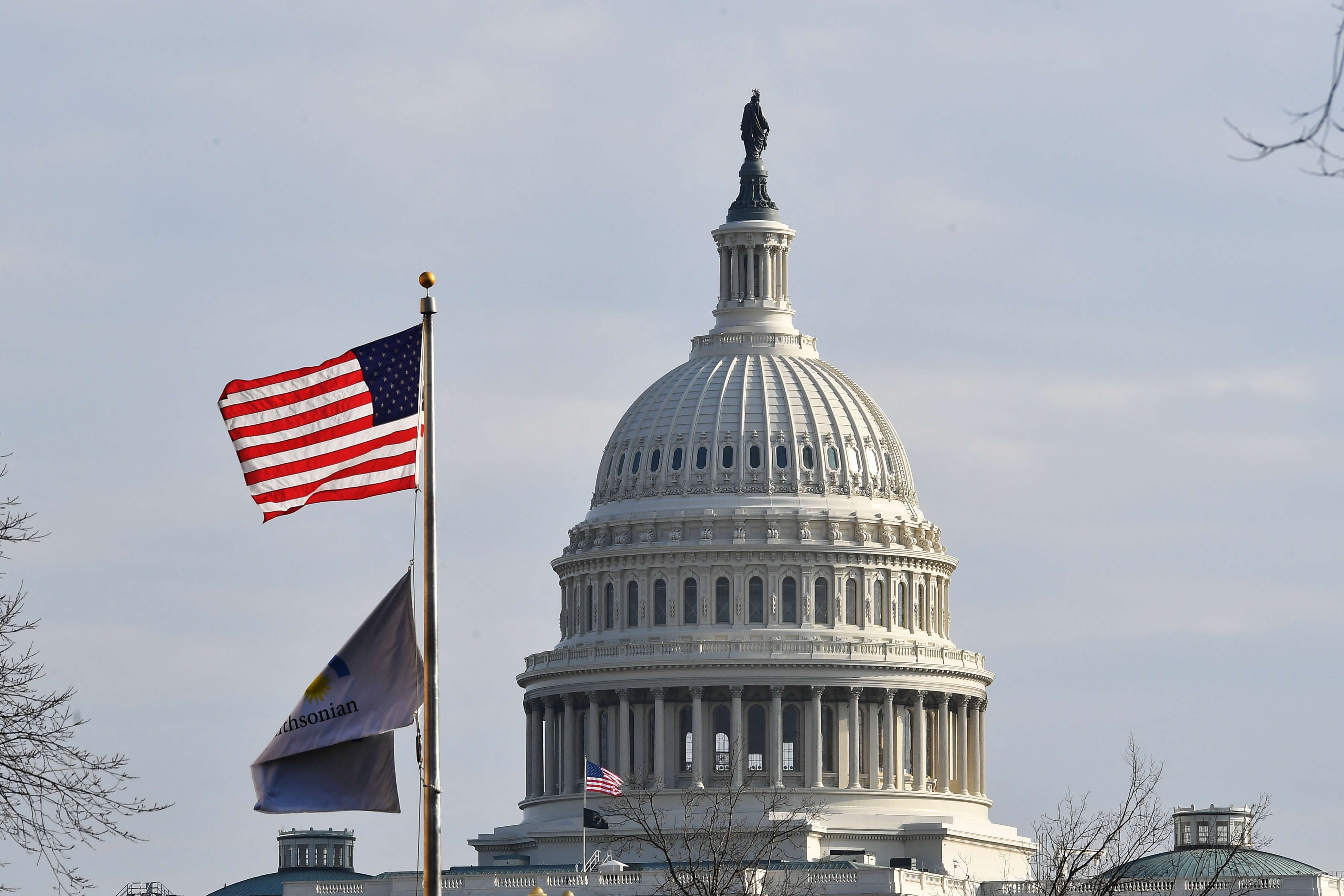 should study abroad in the US: A US flag flies in front of Capitol Hill.