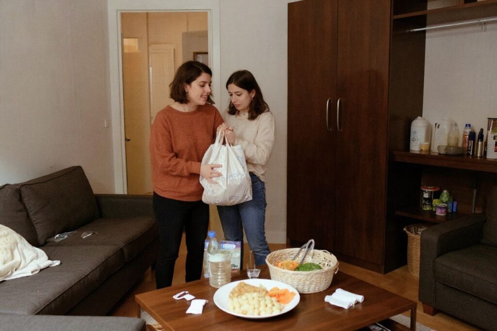 Jimena and Ana, both Spanish students in Erasmus program, are seen in their apartment after receiving a food bag and some sanitary items from the link association which offers all students, whether they have a scholarship or not, food baskets or meals already prepared freely twice a week, in Paris.
Source: Ludovic Marin /