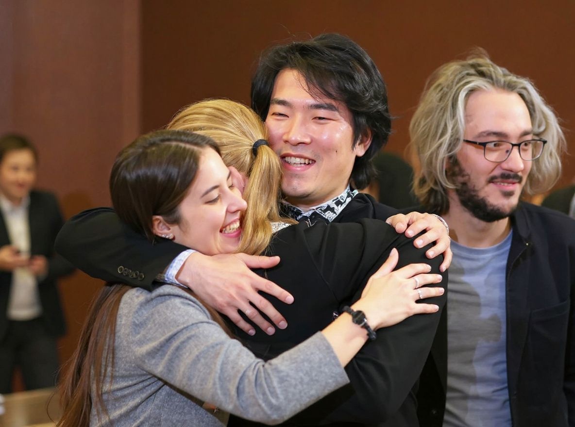 The winner the 18th Chopin competition Canada’s Bruce Xiaoyu Liu hugs Russian-Armenian pianist Eva Gevorgyan after the results were announced, as Leonora Armellini (L) of Italy and Alexander Gadjiev (R) of Italy/Slovenia smile in Warsaw on October 21, 2021. (Photo by JANEK SKARZYNSKI / )