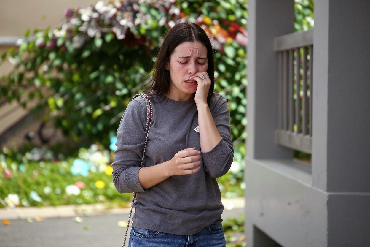BERKELEY, CA – JUNE 16: A woman cries as she leaves flowers at the scene of a balcony collapse at an apartment building near UC Berkeley on June 16, 2015 in Berkeley, California. 6 people were killed and 7 were seriously injured when a balcony collapsed at an apartment building near the University of California at Berkeley campus.   Justin Sullivan/Getty Images/ (Photo by JUSTIN SULLIVAN / GETTY IMAGES NORTH AMERICA / Getty Images via )