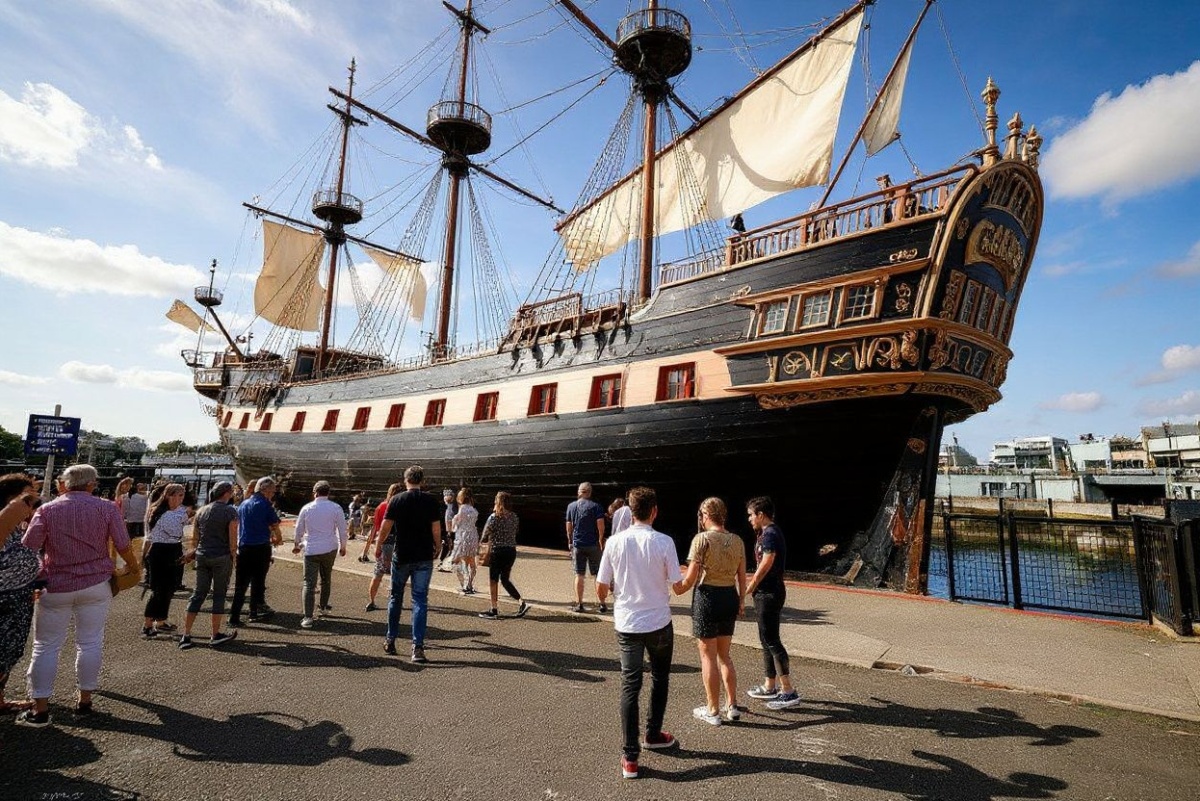 Visitors walk around the stern of HMS Victory, Britain’s most celebrated naval warship as it undergoes a restoration project, “Victory Live: The Big Repair” at Portsmouth Historic Dockyard on the south coast of England on August 21, 2024. – Battleship HMS Victory has survived the cannonballs of Napoleon’s navy, being rammed by another warship, a World War II bomb, even UK navy plans to scrap her. But nearly 260 years after she was launched, Victory — emblem of British maritime heritage and scene of naval hero Horatio Nelson’s death during the Battle of Trafalgar — is facing another equally deadly threat, deathwatch beetle. (Photo by Adrian DENNIS / )