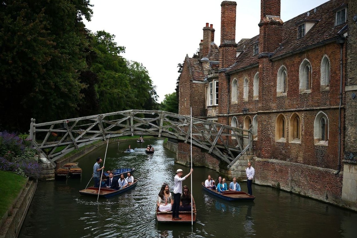 People punt on the River Cam in Cambridge, eastern England, on July 25, 2024. (Photo by HENRY NICHOLLS / )