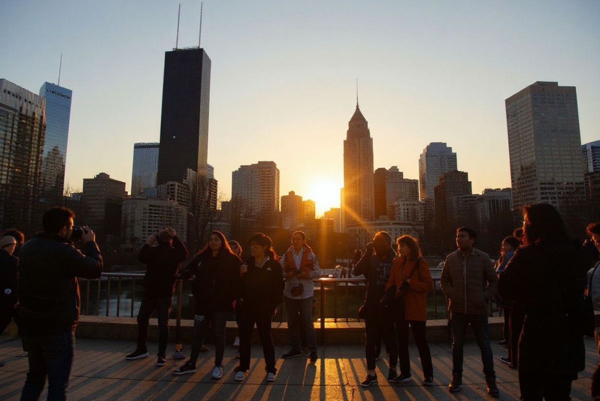 CHICAGO, ILLINOIS – MARCH 22: Photographers, tourists and residents gather downtown to view Chicagohenge on March 22, 2025 in Chicago, Illinois. During Chicagohenge, which occurs at the beginning of spring and again at the beginning of fall, the sun rises and sets in direct alignment with Chicago’s east/west streets making for a picture-perfect moment between the city’s downtown buildings. Scott Olson/Getty Images/ (Photo by SCOTT OLSON / GETTY IMAGES NORTH AMERICA / Getty Images via )