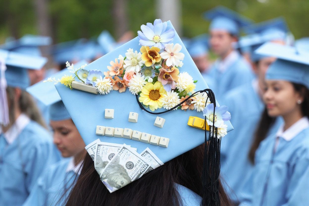 In an effort to stand out, many graduates adorn their caps with their own decorations. Source: