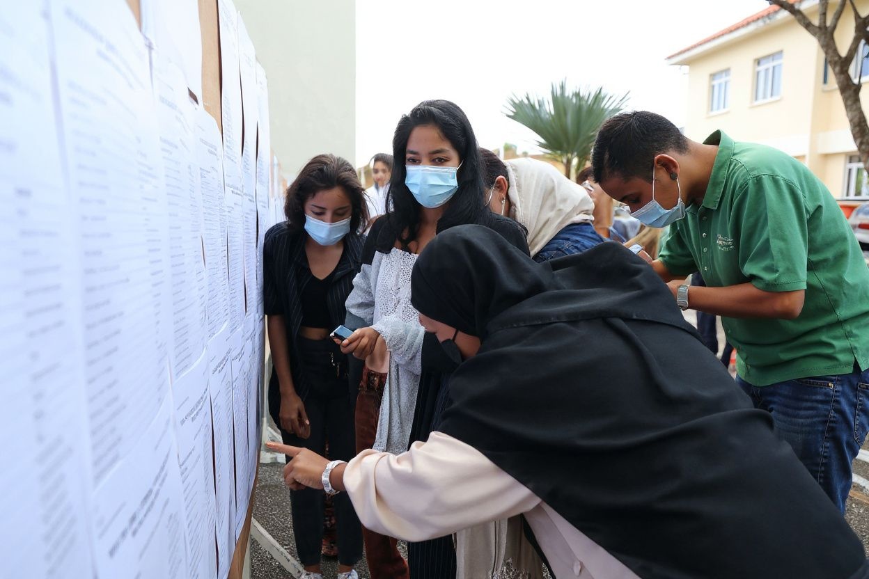 Student check the results of the baccalaureat exam (high school graduation exam) at a high school in Saint-Denis de la Reunion, on the French island of Reunion in the Indian Ocean, on July 6, 2021. (Photo by Richard BOUHET / )