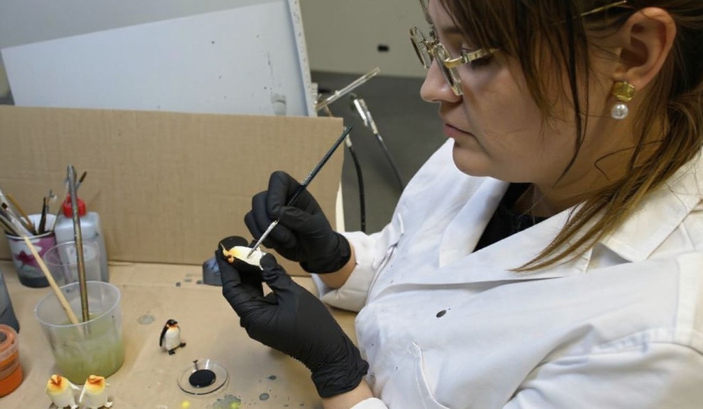 An employee of German toy manufacturer Schleich colors a toy penguin in the painting section of the company’s development center in Schwaebisch Gmuend, southwestern Germany, on December 20, 2023. Schleich produces hand painted authentic and detailed toy figurines for children. (Photo by THOMAS KIENZLE / )