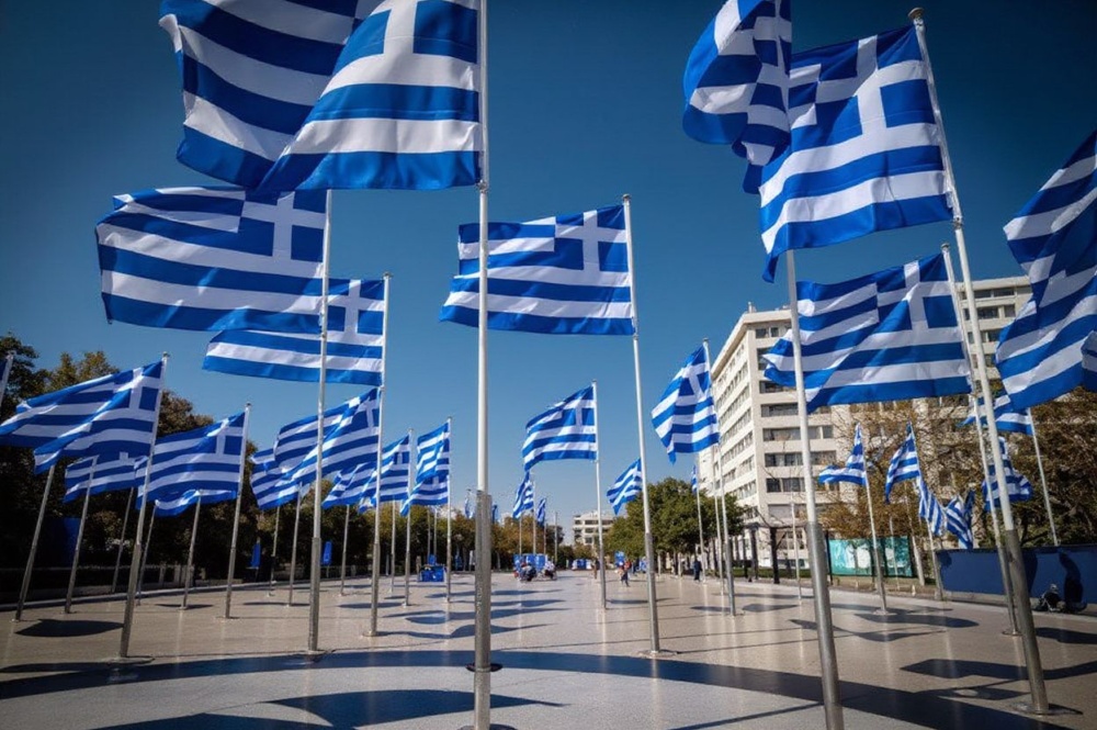 This picture shows Greek flags displayed on the Syntagma square in Athens, on March 24, 2021. The Greeks take great pride in culture and family. Source: Angelos Tzortzinis/