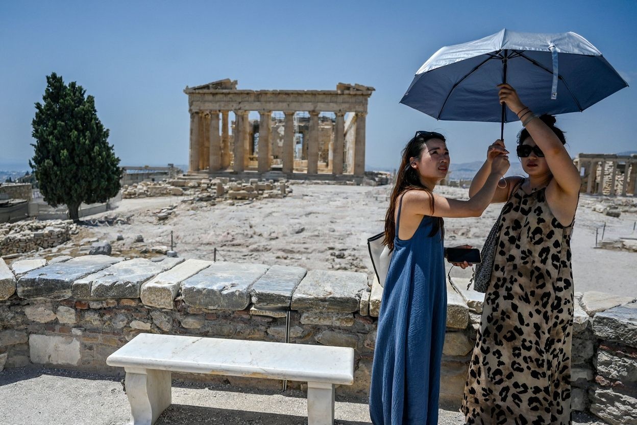 Despite the hot weather in Greece, visitors still flock to the country for the holidays. Source: