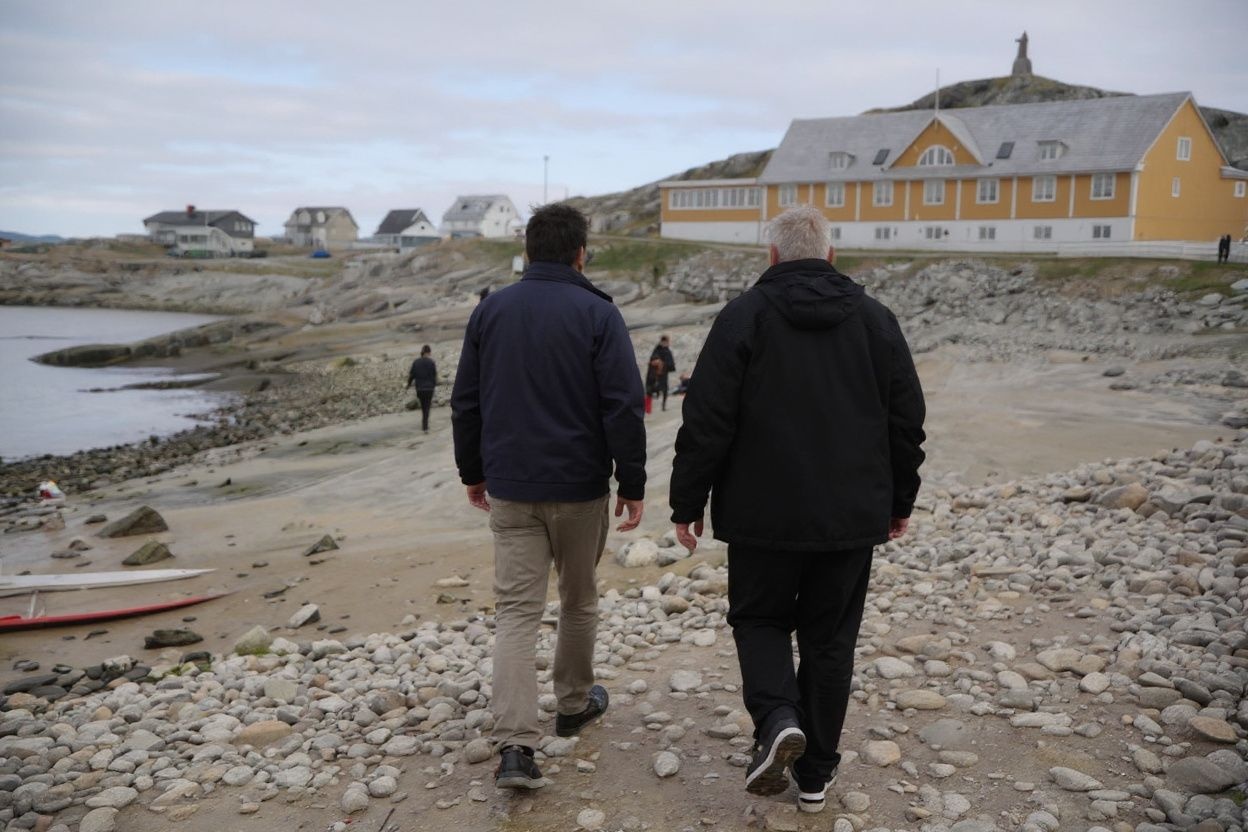 People walk at the beach in Nuuk, Greenland, on June 15, 2025. (Photo by Ludovic MARIN / ) / Denmark OUT / DENMARK OUT / DENMARK OUT