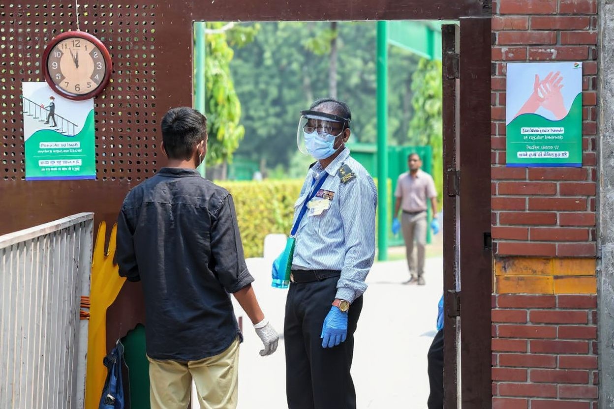A students (L) credentials are checked at the entrance of an examination centre before taking the National Eligibility cum Entrance Test (NEET), one of the most competitive entrance exams for entry to top national medical colleges in India. Source: Prakash Singh/