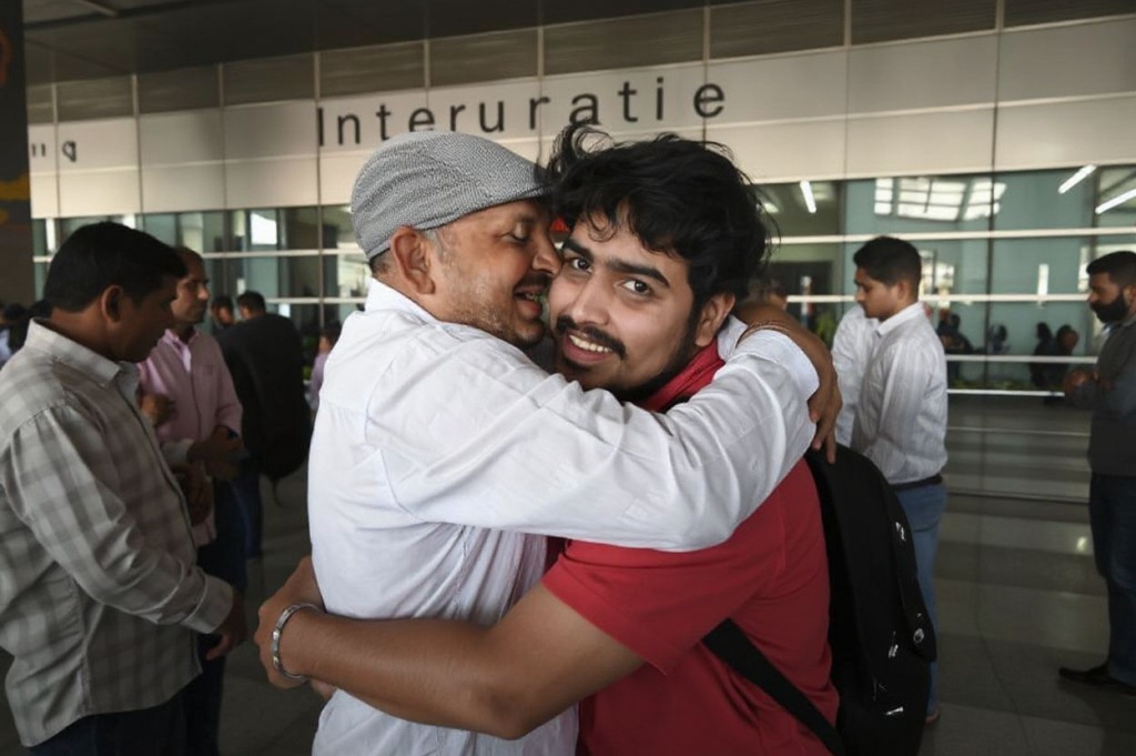 A relative hugs a student (R) evacuated from Ukraine after arriving on a special flight at Indira Gandhi International Airport in New Delhi on March 3, 2022. (Photo by Money SHARMA / )