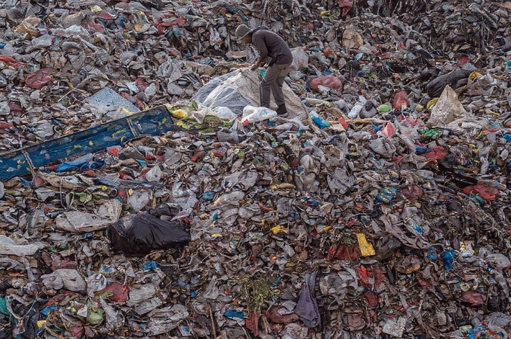 A ragpicker searches for recyclable materials at a landfill in Sidoarjo on September 16, 2022. (Photo by JUNI KRISWANTO / )