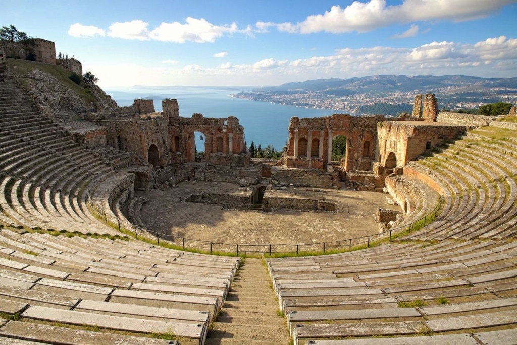 An old Greek theatre in the Sicilian village of Taormina. Source: .