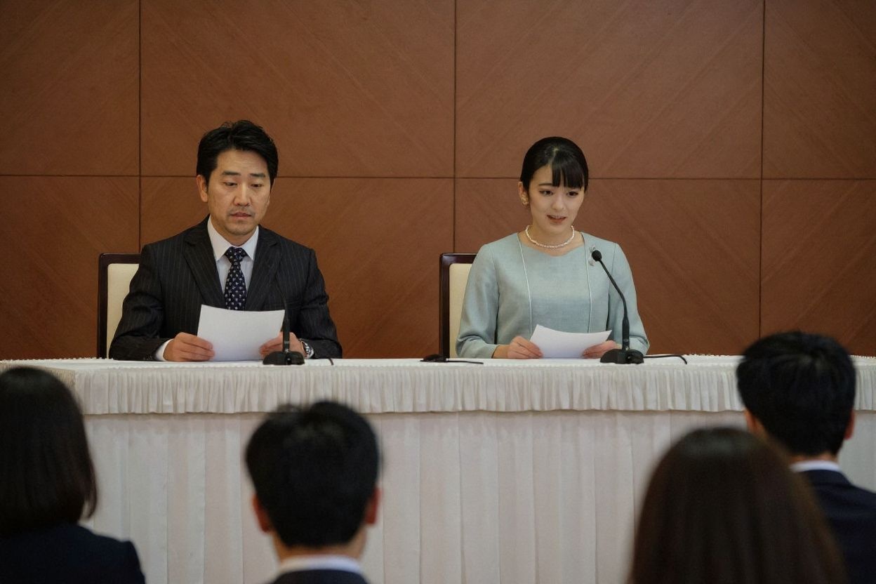 Japan’s former princess Mako (R), the elder daughter of Prince Akishino and Princess Kiko, and her husband Kei Komuro (L), who she originally met while at university, speak during a press conference to announce their marriage registration, at the Grand Arc Hotel in Tokyo on October 26, 2021. (Photo by Nicolas Datiche / POOL / )