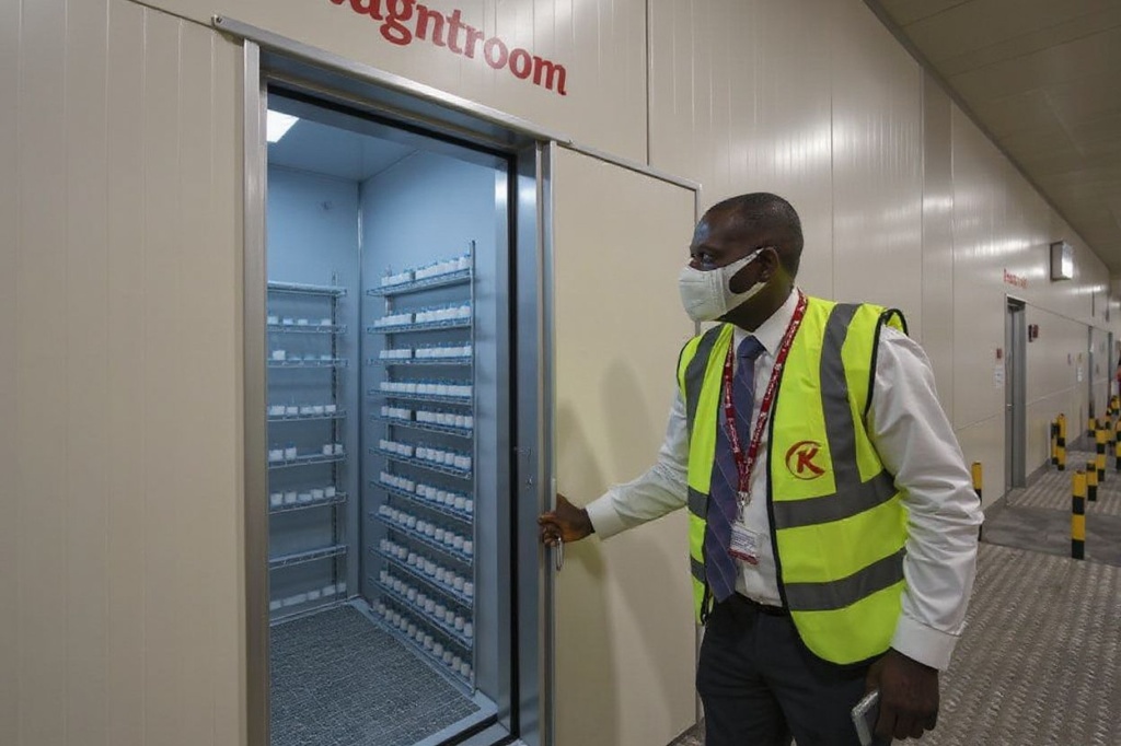 Kenya’s national carrier, Kenya Airways’ Commercial Cargo Manager, Peter Musola unlocks a sub-freezing coldroom to be used for the storage of vaccines that require below-zero temperature storage at the airlines import handling facility at the Jomo Kenyatta International Airport (JKIA) in Nairobi February 11, 2021. Kenya Airways Cargo has invested in an ultra-modern pharma facility aimed at bridging the cold-chain supply of temperature-sensitive pharmaceuticals transiting through Nairobi, with an immediate focus on the logistics of the Covid-19 vaccine. Kenya Airways wants to become a lead distributor of coronavirus vaccines in Africa and spies an advantage when competing to transport the temperature-sensitive vials — its expertise in getting fresh roses to Europe. (Photo by Tony Karumba / )