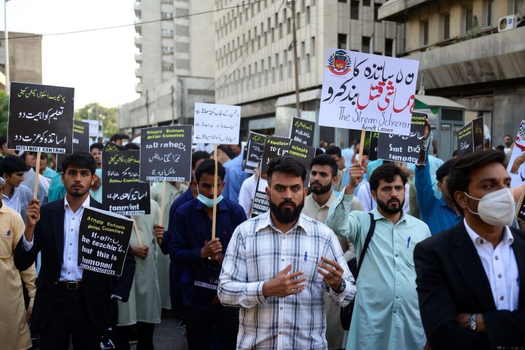 Private school students and teachers carry placards during a demonstration demanding the government to reopen all educational institutes, which are closed since last month to contain the spread of the Covid-19 coronavirus in Karachi on April 12, 2021. (Photo by Asif HASSAN / )
