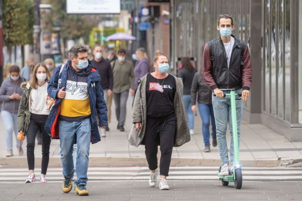 People wearing protective masks are seen on the streets of Warsaw after the Polish government introduced mandatory mouth and nose coverage in public places, on October 10, 2020. Source: Wojtex Radwanski/