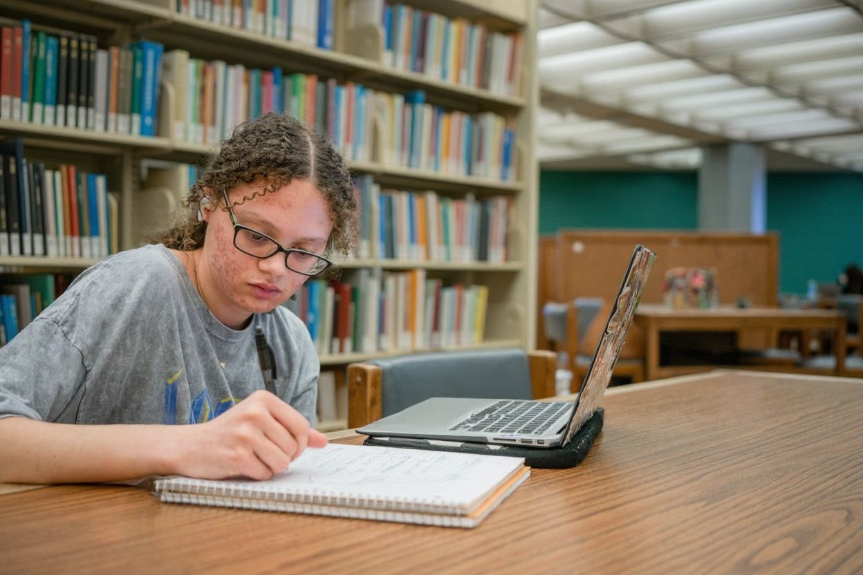 Libraries are great places to study if you want to pull a brutal all-nighter., shot on Sony A7R IV, 85mm f/1.4 lens, RAW photograph, unedited, candid moment, natural lighting, photojournalistic style | NEGATIVE: AI generated, artificial, computer generated, digital art, 3d render