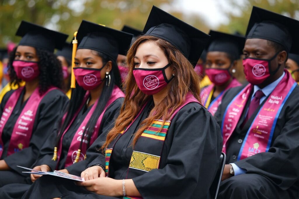 Students attend their graduation ceremony at South Carolina State University on December 17, 2021, in Orangeburg, South Carolina. – US President Joe Biden gave the commencement address. (Photo by MANDEL NGAN / )