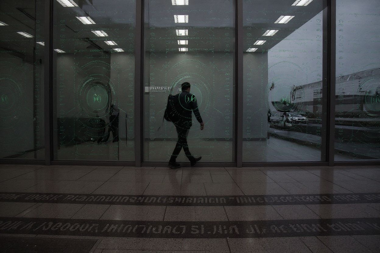 (FILES) A picture taken on October 17, 2016 shows an employee walking behind a glass wall with machine coding symbols at the headquarters of Internet security giant Kaspersky in Moscow. – The US government banned the use of Kaspersky security software in federal offices on September 13, 2017, saying the Russian company has risky ties to Russian intelligence that threaten US national security. (Photo by KIRILL KUDRYAVTSEV / )