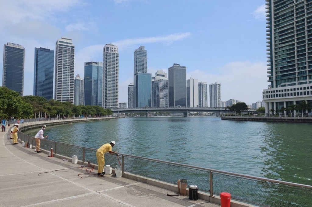 Workers cleaning the spectators gallery along the Marina Bay next to Mandarin Oriental hotel in Singapore on March 26, 2021. (Photo by Roslan RAHMAN / )