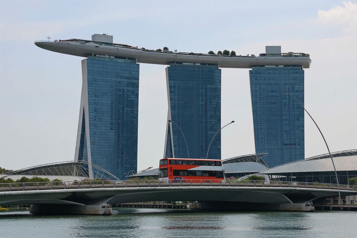 A public bus plies across the bridge in front of the Marina Bay Sands Hotel in Singapore. Source: