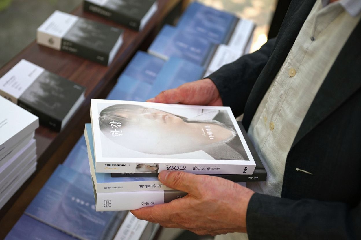 If you’re a successful author, perhaps you’ll have to endure long signing sessions, but they’re once in a blue moon., shot on Nikon D850, 35mm f/1.8 lens, RAW photograph, unedited, candid moment, natural lighting, photojournalistic style | NEGATIVE: AI generated, artificial, computer generated, digital art, 3d render