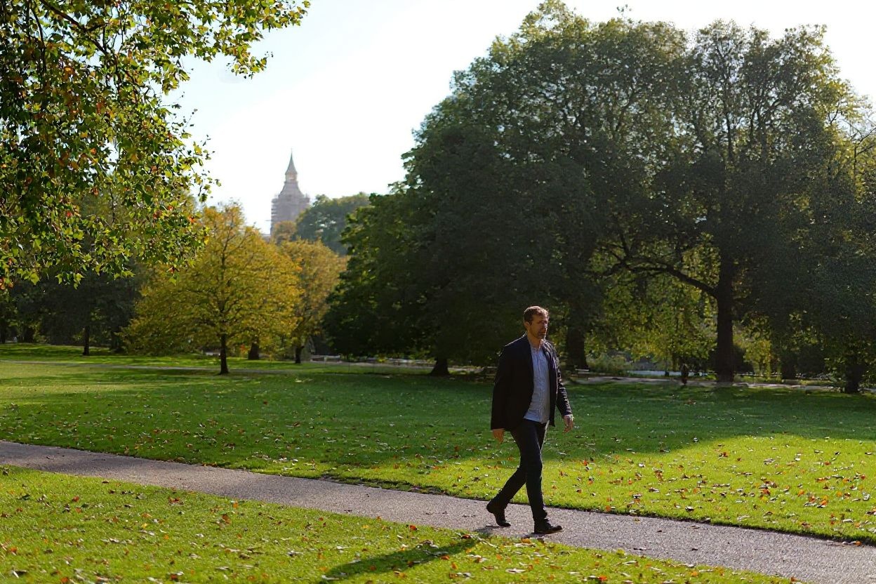 A man walks past fallen autumn leaves at St James’ Park in central London on October 22, 2021. Source: Tolga Akmen/
