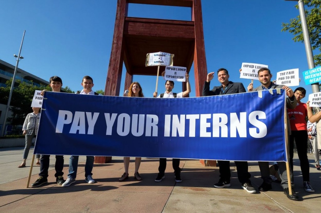 Unpaid interns at the United Nations in Geneva hold a banner during demonstration organised by The Fair Internship Initiative (FII), a network of interns calling for the UN to offer paid internships. Source: . 