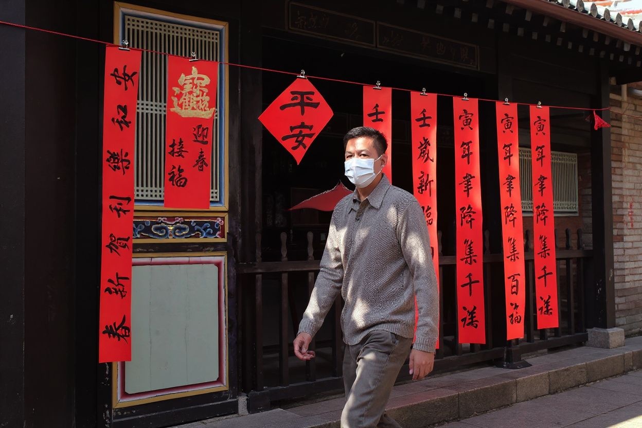 A man walks past calligraphies showing Chinese characters to mark the coming Chinese Lunar New Year of Tiger at the Confucius temple in Taipei on January 15, 2022. (Photo by Sam Yeh / )