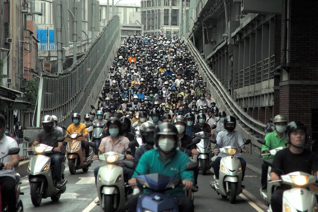 Motorcyclists ride down the congested exit of the Taipei bridge during rush hour on August 6, 2021. (Photo by Sam Yeh / )