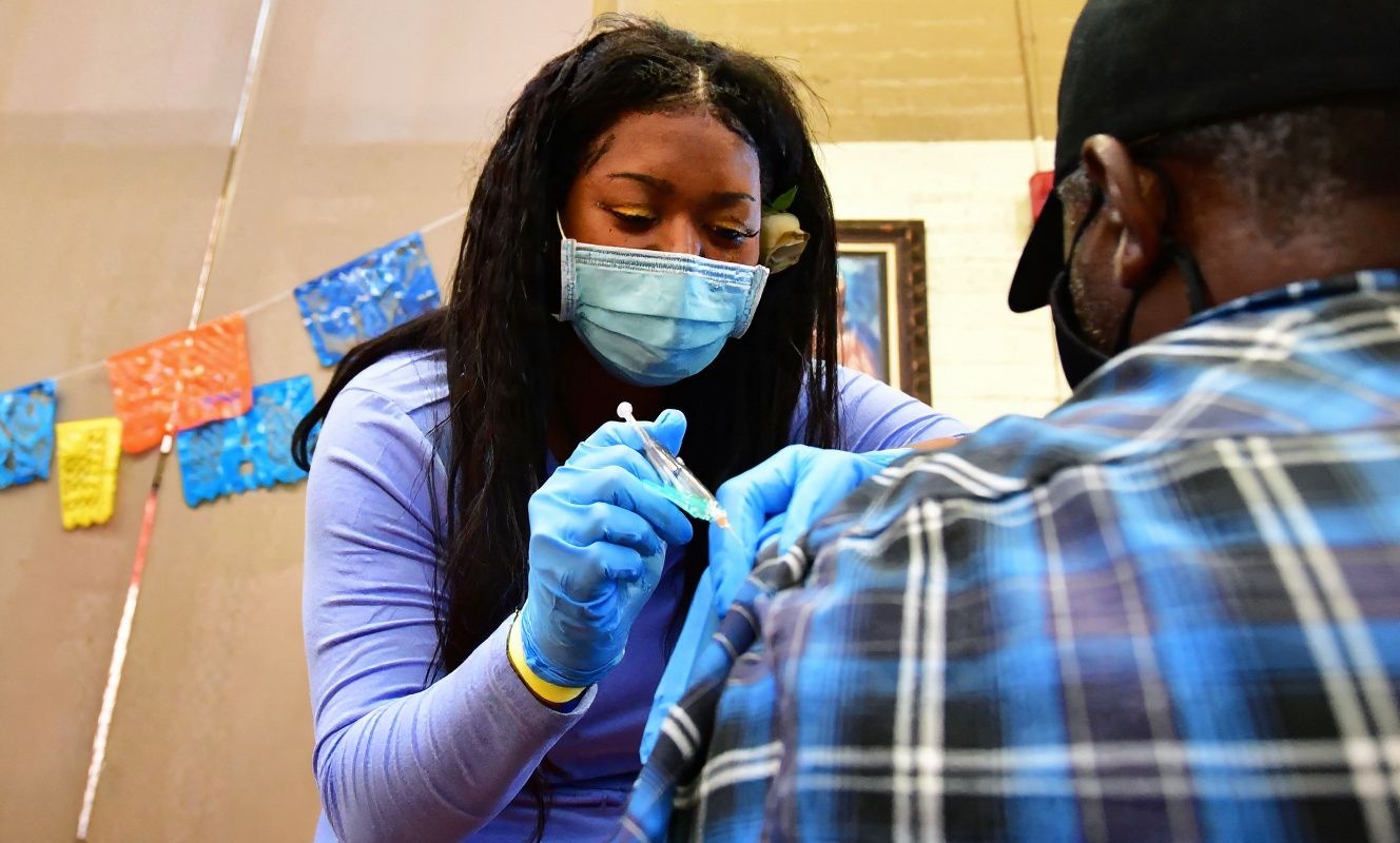 The CDC recommends having at least one booster shot to help you mitigate Omicron symptoms if you’re infected. Source: Frederic J. Brown/