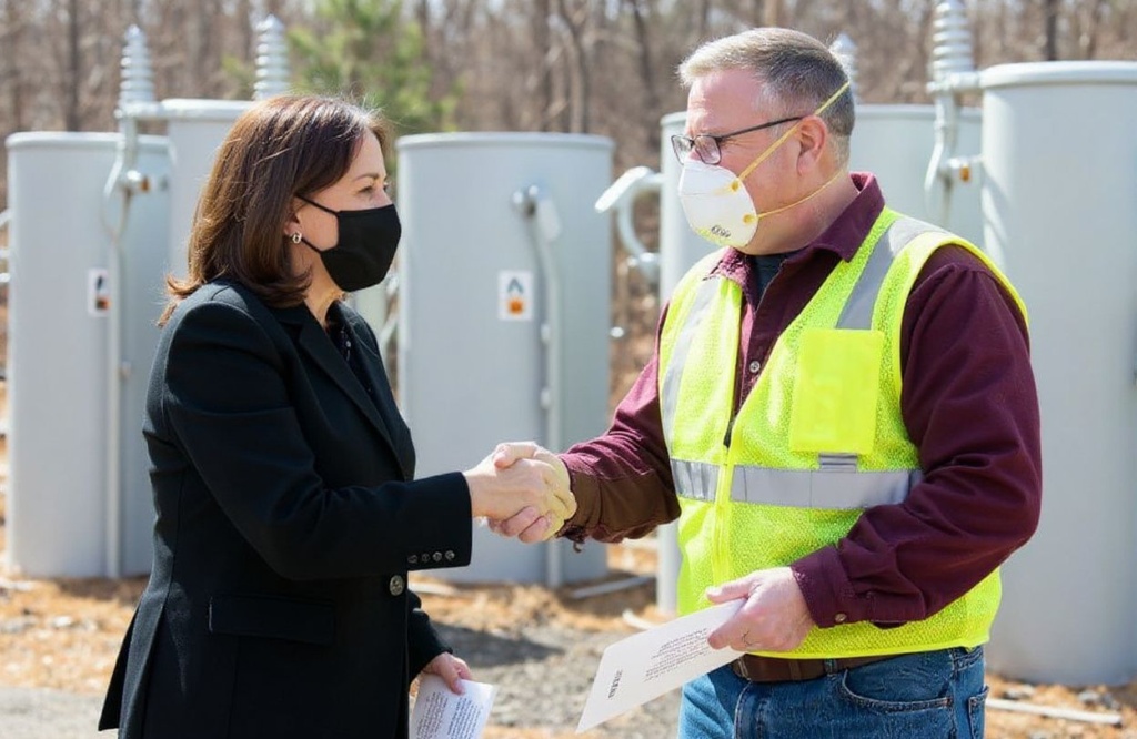 US Vice President Kamala Harris greets Jeff Bird (R), IBEW Line Design Technician, during a listening session on broadband internet at the New Hampshire Electric Co-op in Plymouth, New Hampshire, April 23, 2021, as she travels to the state to promote the administration’s economic plans. (Photo by SAUL LOEB / )