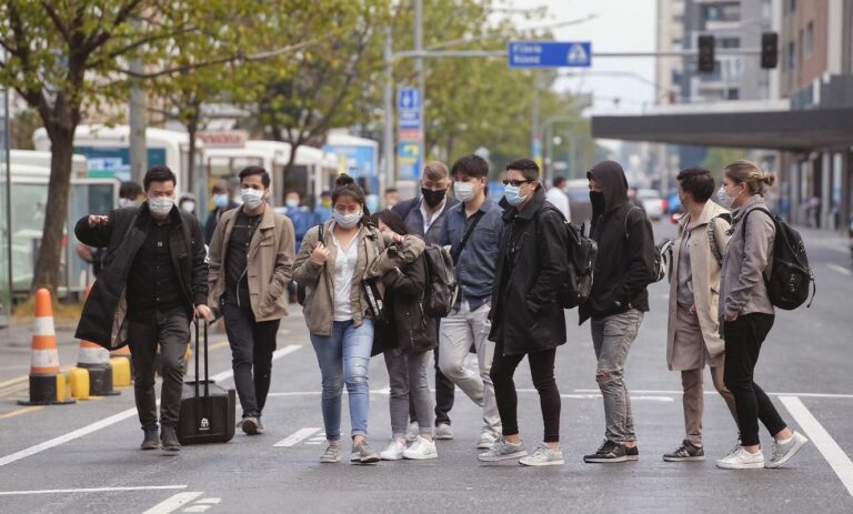 Fewer flights from China are flying to Australia, but some students are relieved by the delay